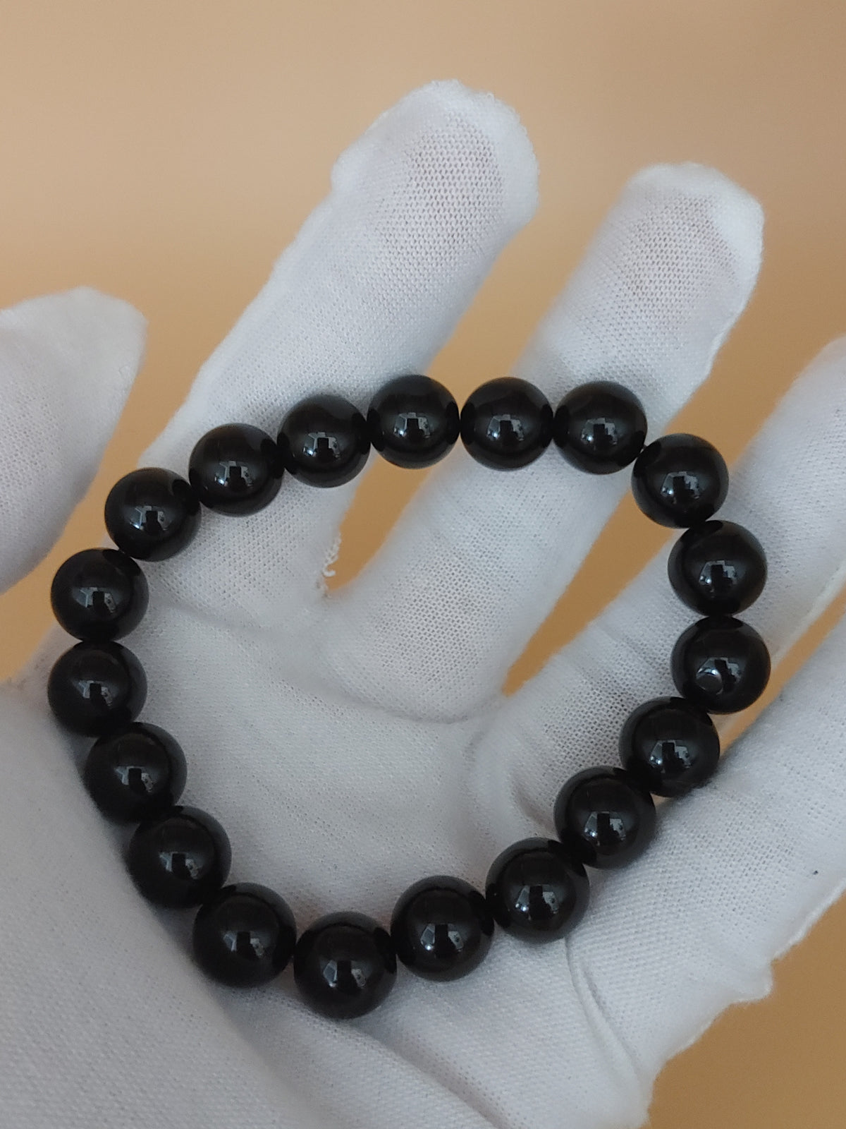 Jet Black 10.3 mm Obsidian Bracelet (#B905) - hand-held view