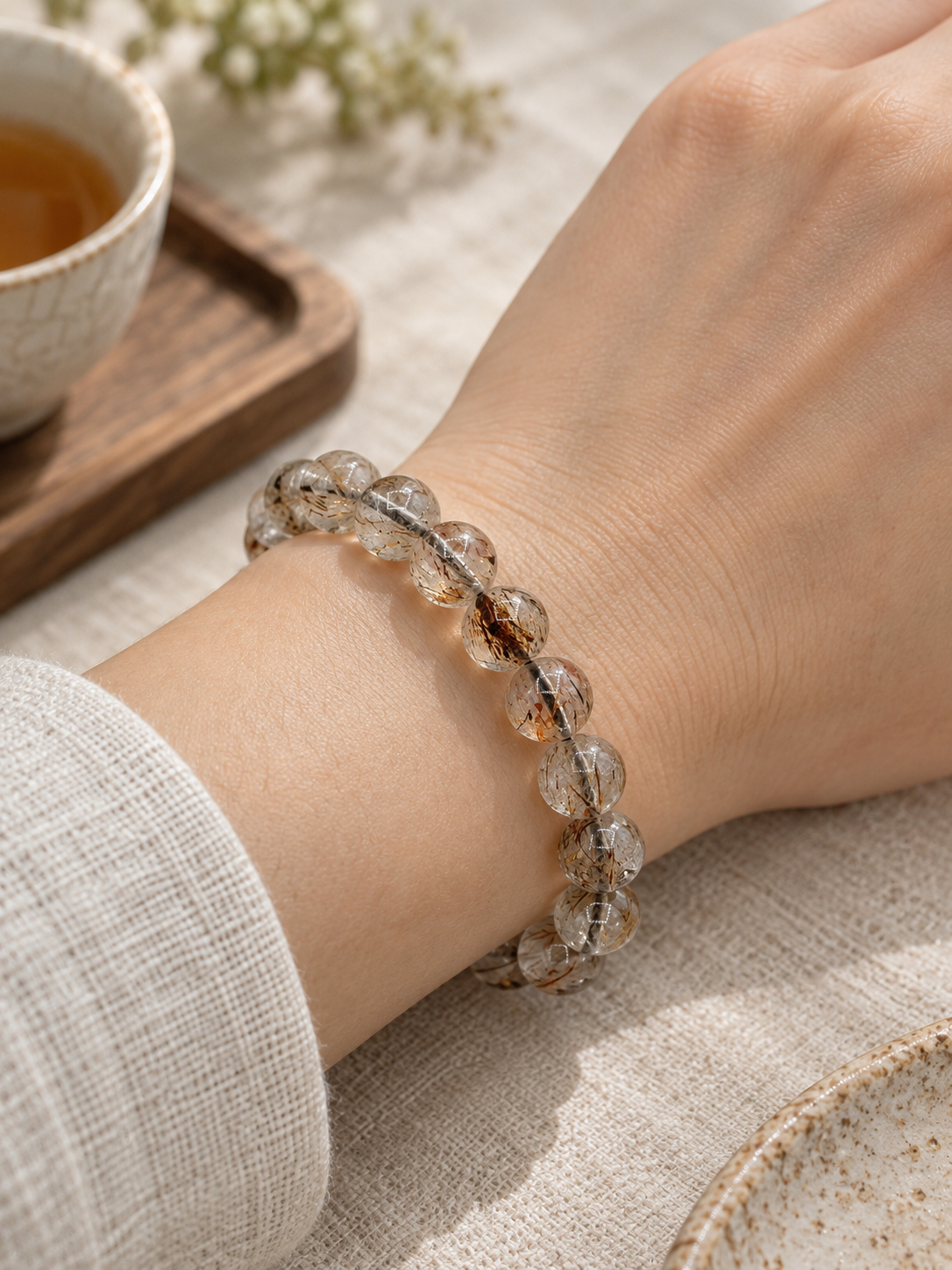 Golden Needle 10.4 mm Super Seven crystal bracelet worn on a wrist