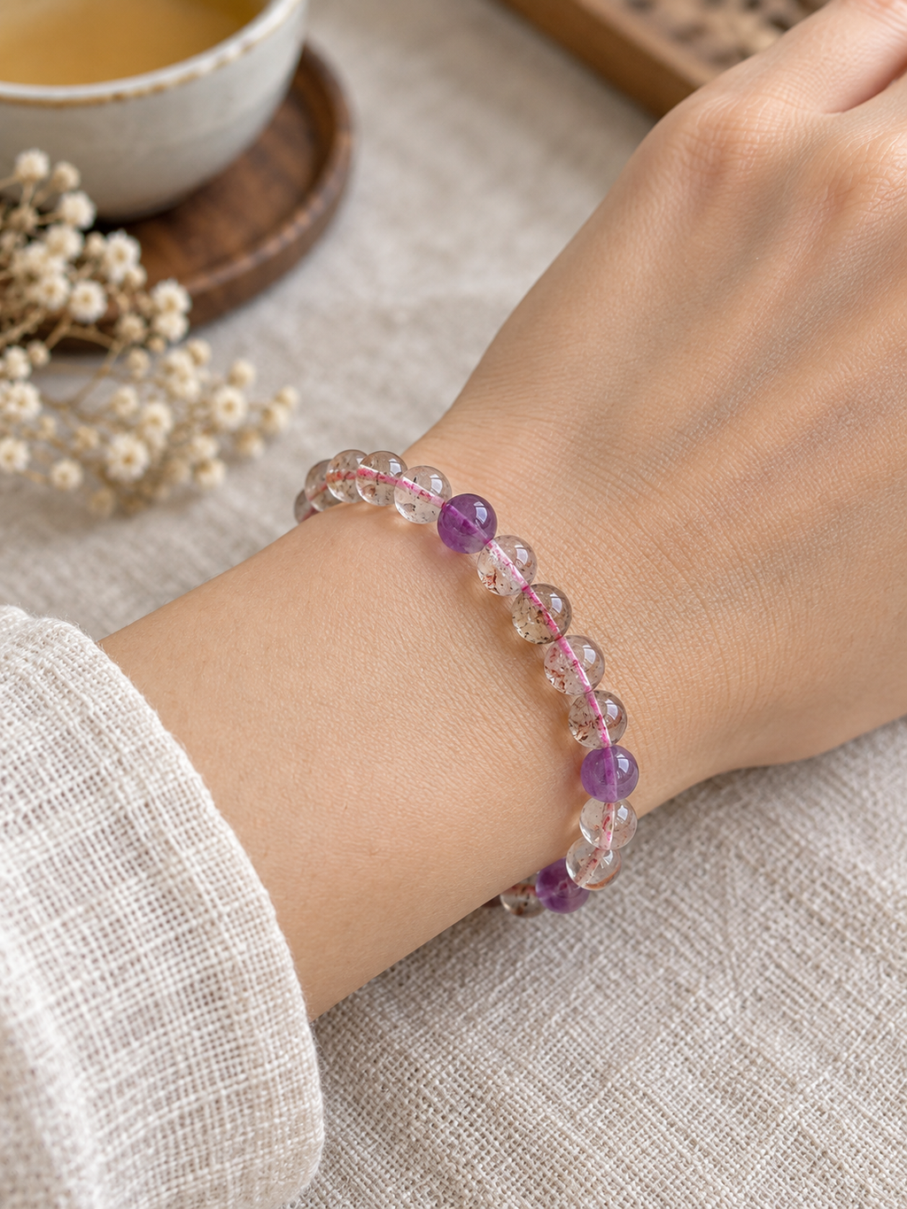 Violet Accent 6.8 mm Super Seven crystal bracelet worn on a wrist