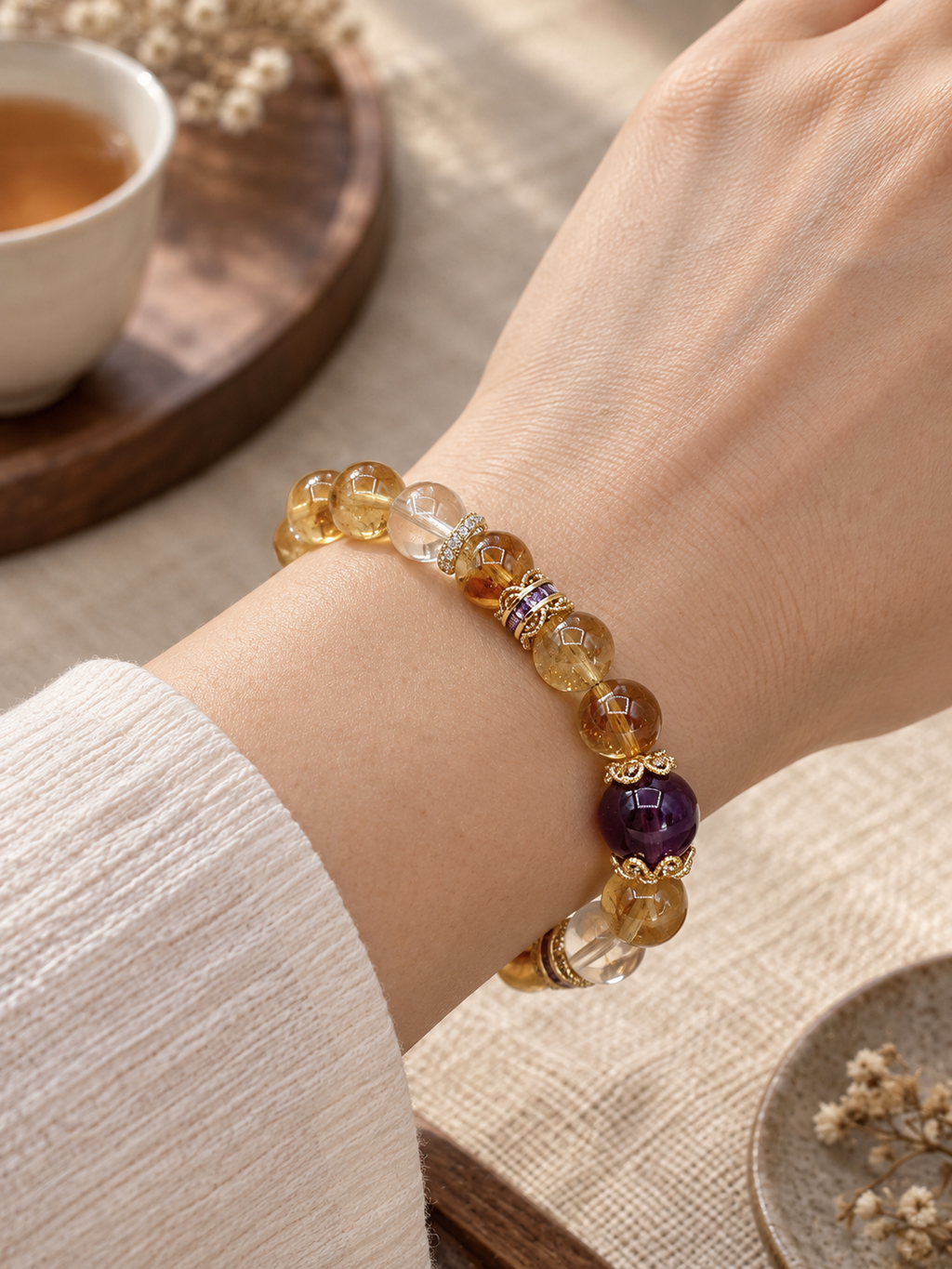 Golden Thread Super Seven crystal bracelet with violet focal bead worn on a wrist